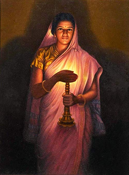 An Indian girl with a pink-lavender saree holding a diya, covering its light with her hand.