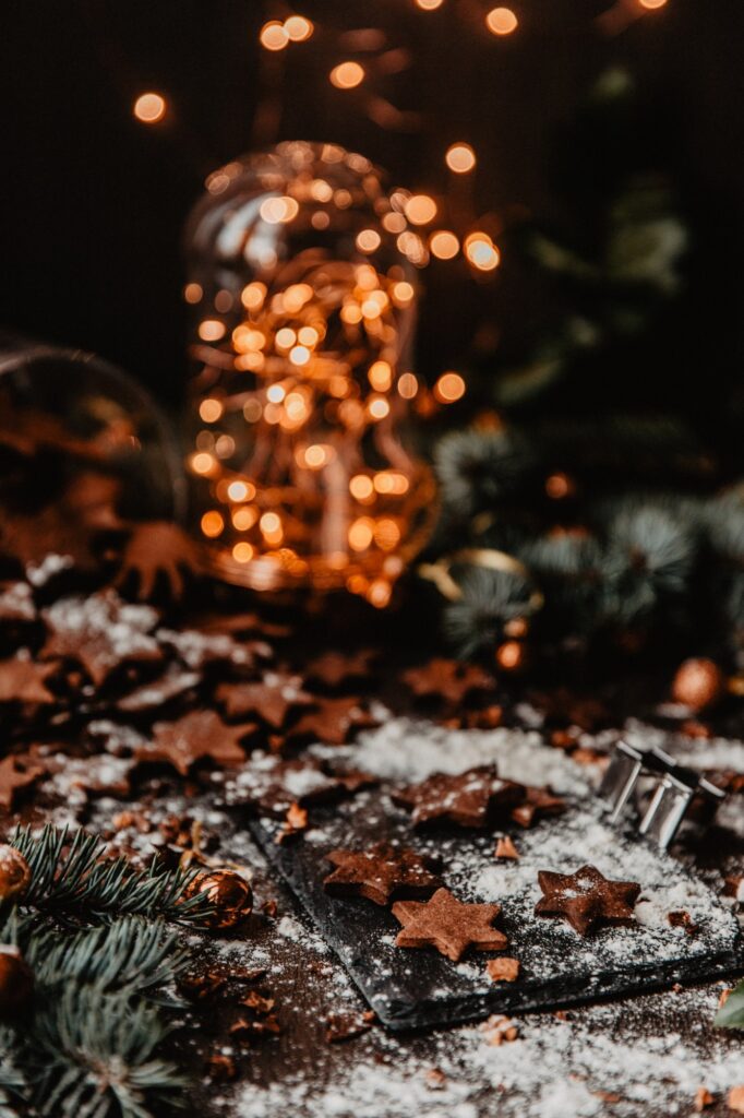 Christmas cookies surrounded by powdered sugar and Christmas decorations 