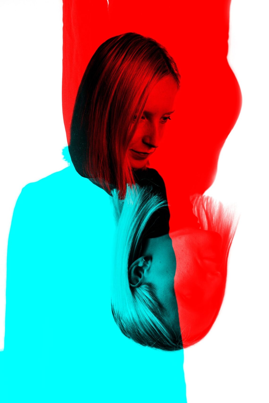 Mirrored image. A girl upside down and on the regular side in blue and red colours.